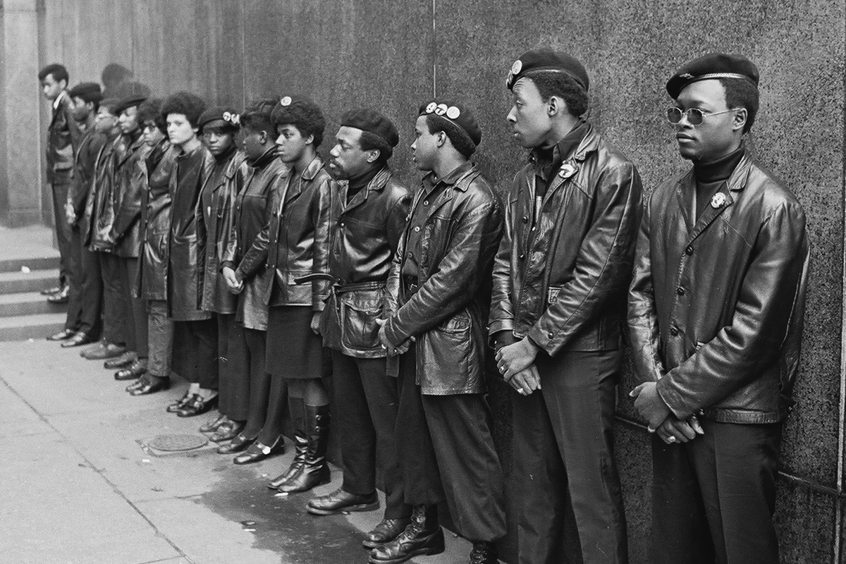 In zwarte leren vesten en broeken liepen mannen en vrouwen van de Black Panthers in groep door de straten van Oakland om politieacties gade te slaan